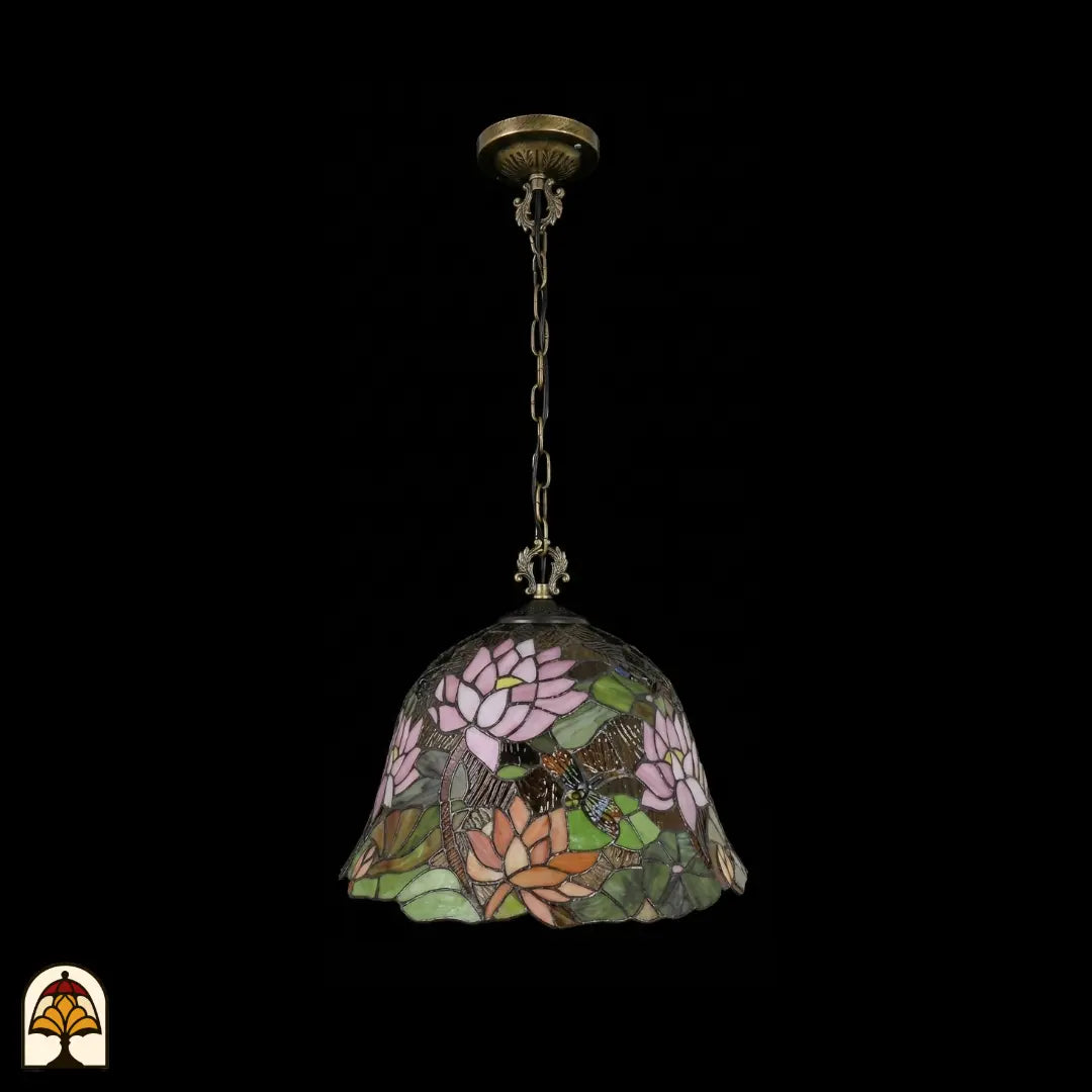 Tiffany lamp hanglamp onverlicht, volledig beeld met bronzen plafondrozet en bronzen ketting, klokvormige kap met roze en oranje lotusbloemen, groene waterleliebladen en libelle in glas-in-lood, gekartelde rand